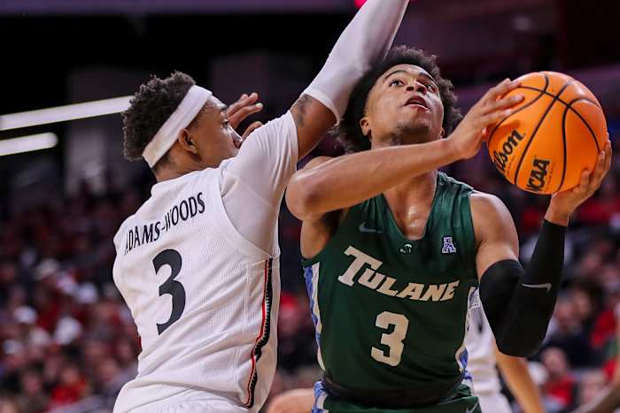 Dec 29, 2022; Cincinnati, Ohio, USA; Tulane Green Wave guard Jalen Cook (3) drives to the basket against Cincinnati Bearcats guard Mika Adams-Woods (3) in the second half at Fifth Third Arena. Mandatory Credit: Katie Stratman-USA TODAY Sports